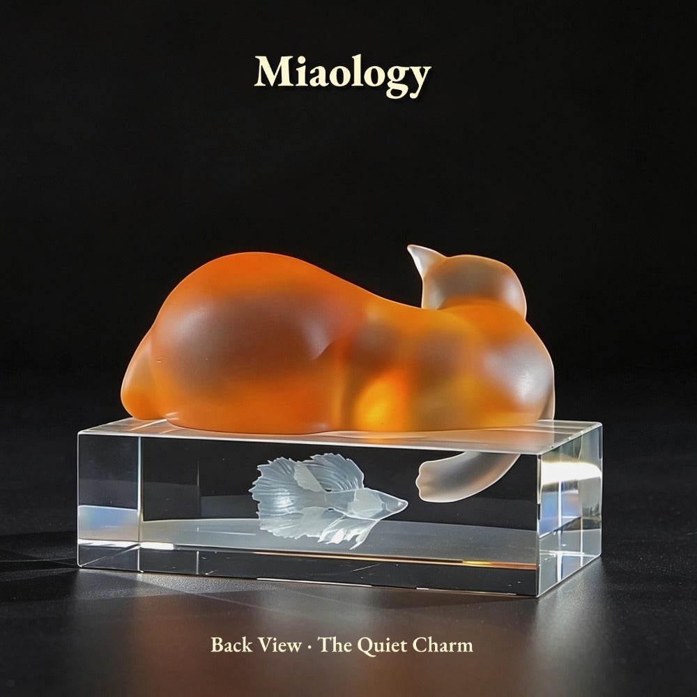 Orange and white cat-shaped object on a clear base with 'Miaology' branding.