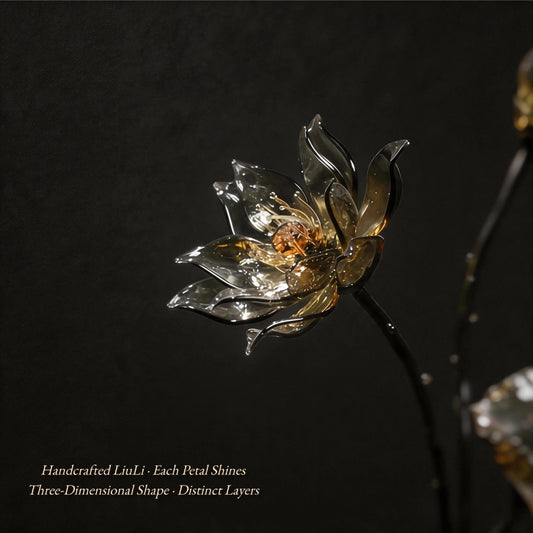 Handcrafted glass lotus flower with metallic sheen on a dark background