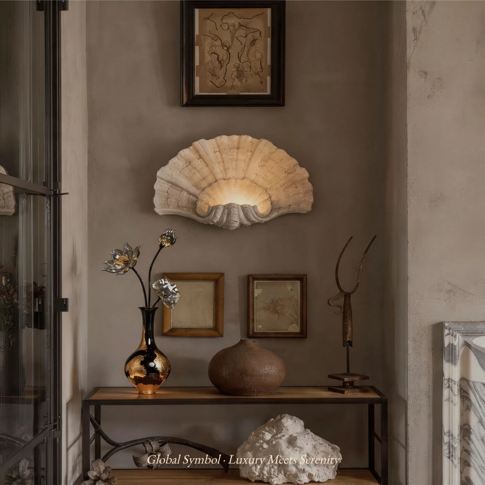 Decorative wall light fixture with framed artwork and sculptures in a room setting.