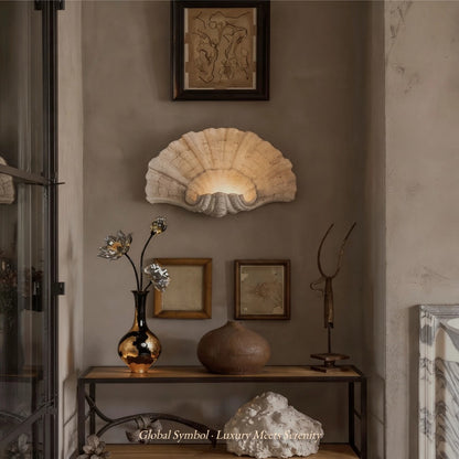 Decorative wall light fixture with framed artwork and sculptures in a room setting.