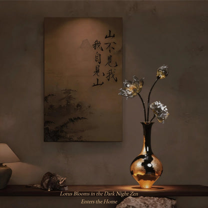 Decorative setup with a vase of luxury glass lotus flowers, and a piece of art on a wall.