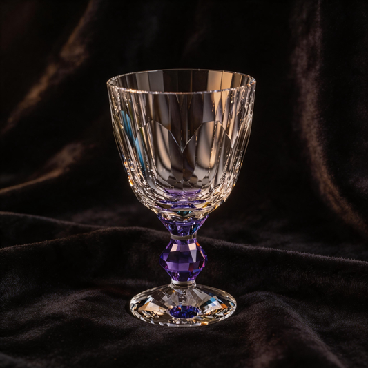 Crystal glass with purple base on a dark fabric background