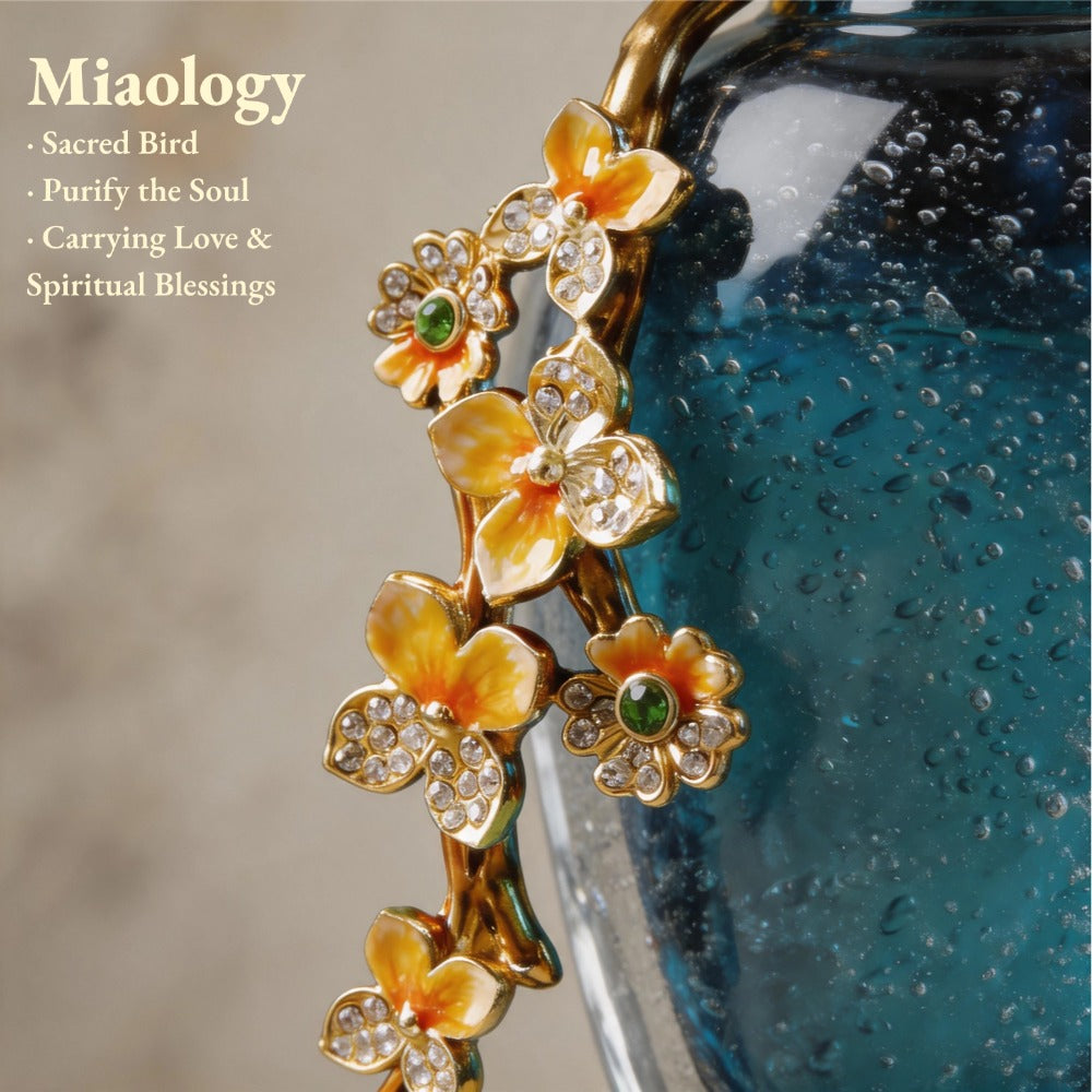Decorative flower-shaped object with gold and orange details against a blurred background